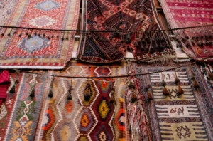 Colorful patterned rugs hanging for display